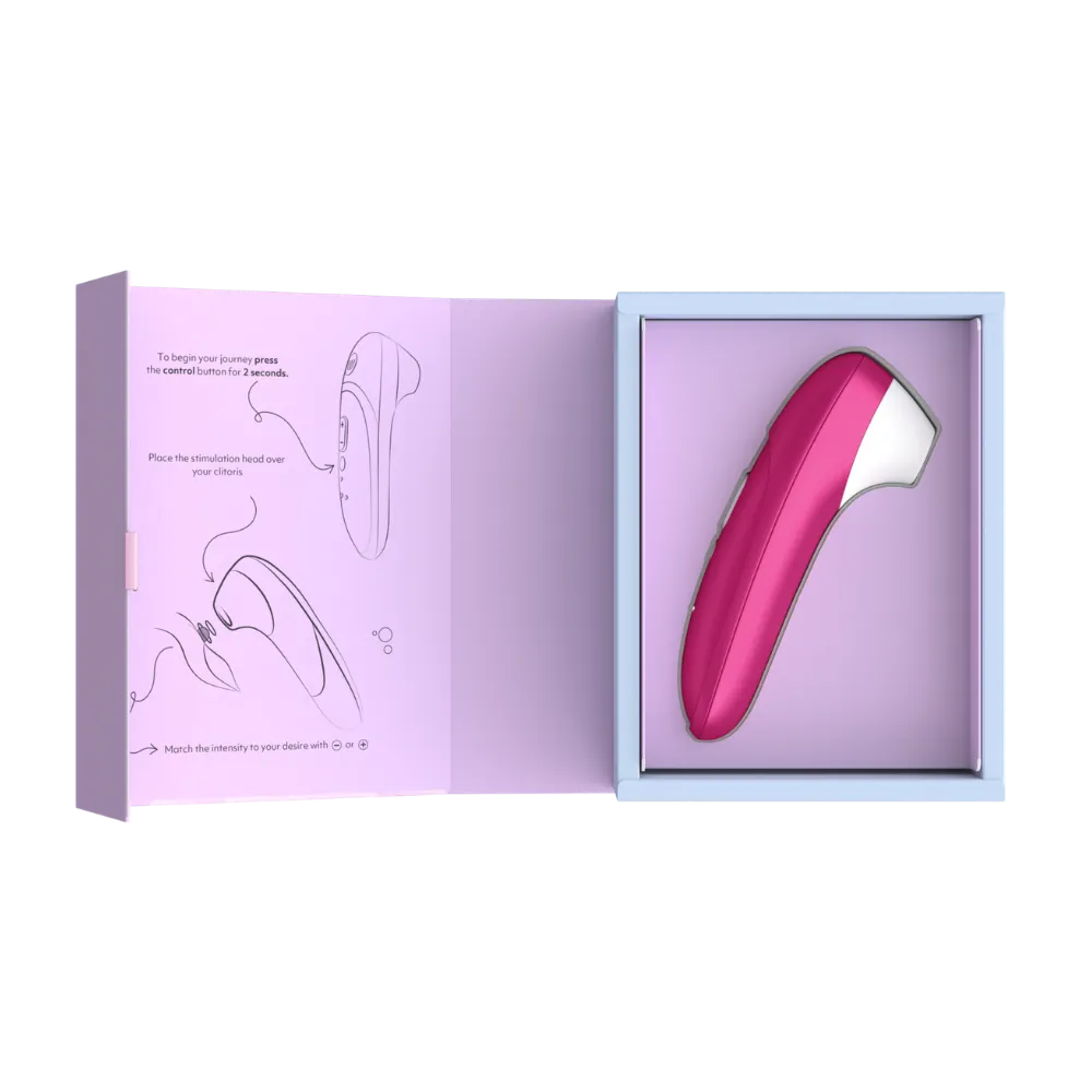 Womanizer Pro lufttryksvibrator i vibrant pink præsenteret i åben gaveæske med illustreret vejledning. Stilfuldt sexlegetøj til kvinder med Pleasure Air teknologi udviklet til præcis og behagelig klitorisstimulering.