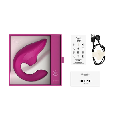 Womanizer Blend sexlegetøj med tilbehør som USB-oplader og brugervejledning. Billedet viser alt indhold i pakken til lufttryksvibratoren.