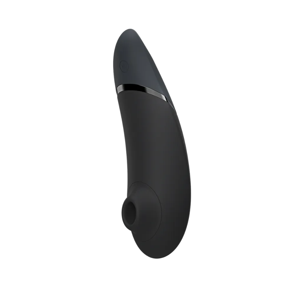 Womanizer Next i sort set ovenfra med power-knap, sensorpunkt og stilrene knapper. Kompakt og diskret klitorisstimulator.