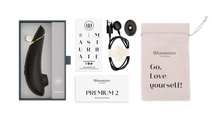 Womanizer Premium 2 i original æske med tilbehør, oplader, opbevaringspose og brugermanual – luksuriøst lufttryksprodukt til kvindelig nydelse.