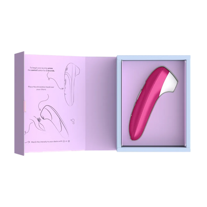Womanizer Pro lufttryksvibrator i vibrant pink præsenteret i åben gaveæske med illustreret vejledning. Stilfuldt sexlegetøj til kvinder med Pleasure Air teknologi udviklet til præcis og behagelig klitorisstimulering.